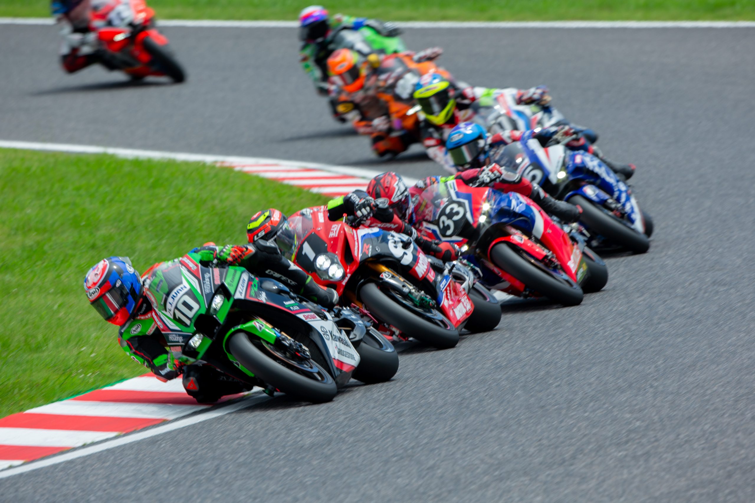 line of superbikes on track