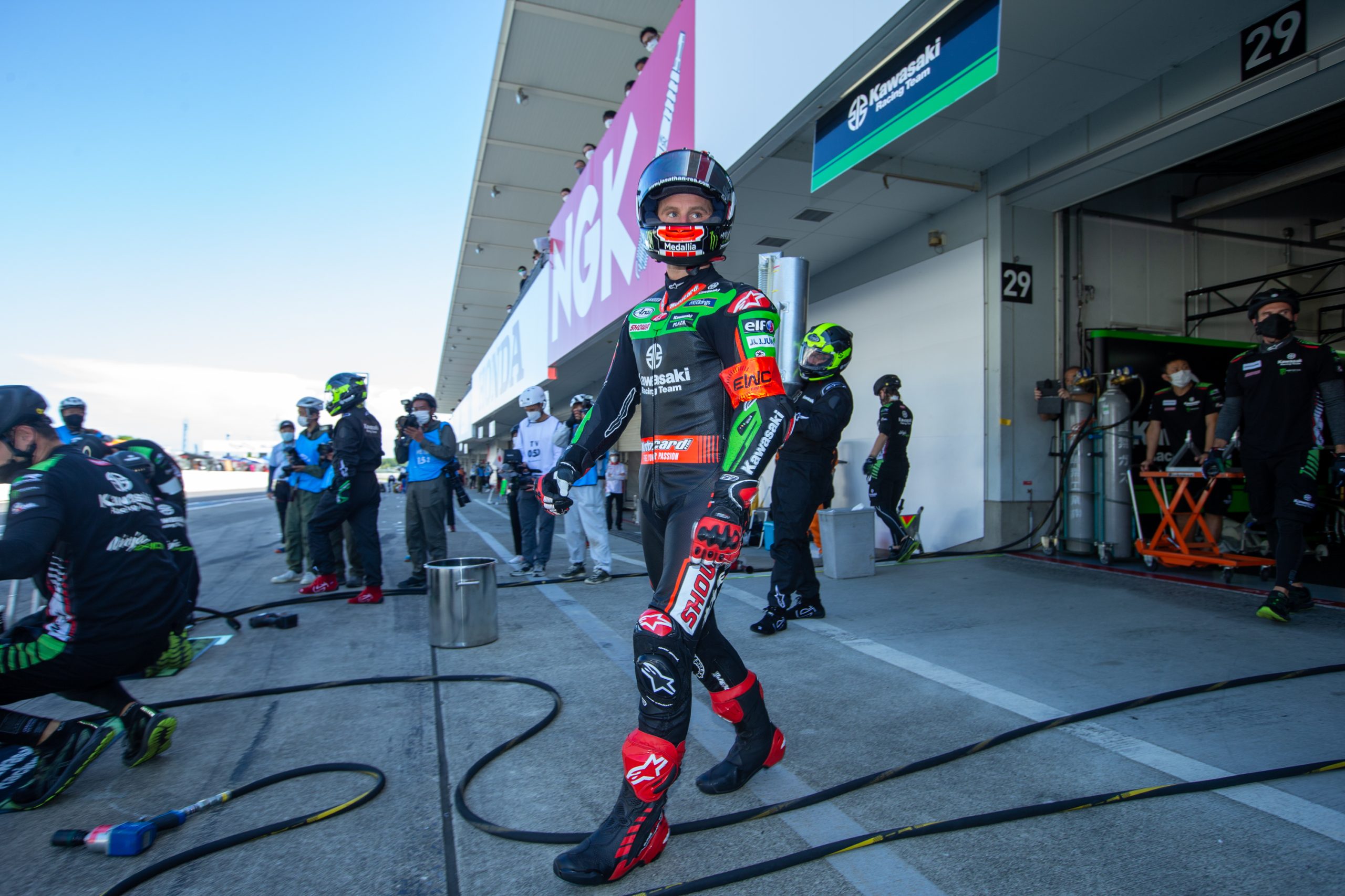 rider walking across pit area